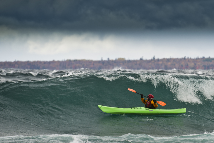 A sea kayaker in rough water storm conditions on Lake Superior in Ontario Canada.