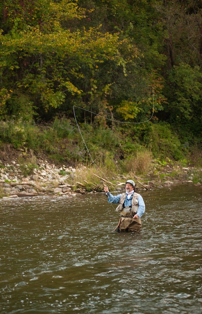 An Angler fly fishing for trout on the Ahuriri river, surrounded