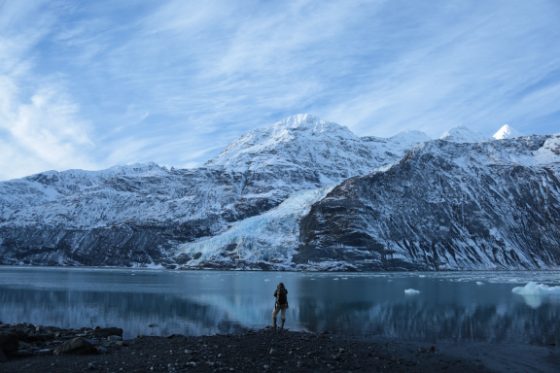 Jody MacDonald taking photos in front of a mountain range.