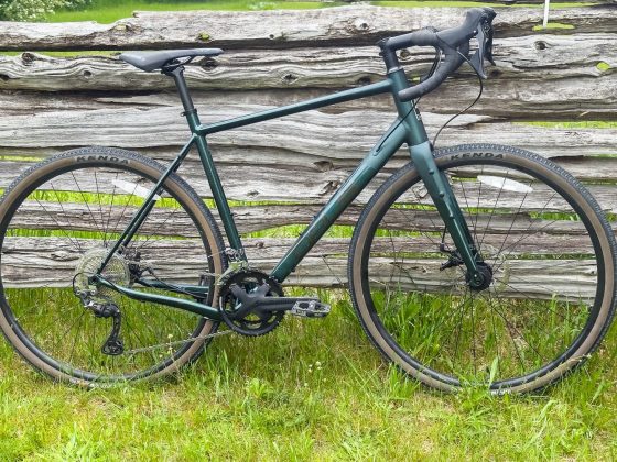 Opus Horizon gravel bike against a fence.