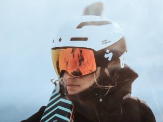 a woman wearing snow googles and helmet