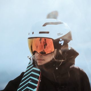 a woman wearing snow googles and helmet
