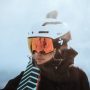 a woman wearing snow googles and helmet