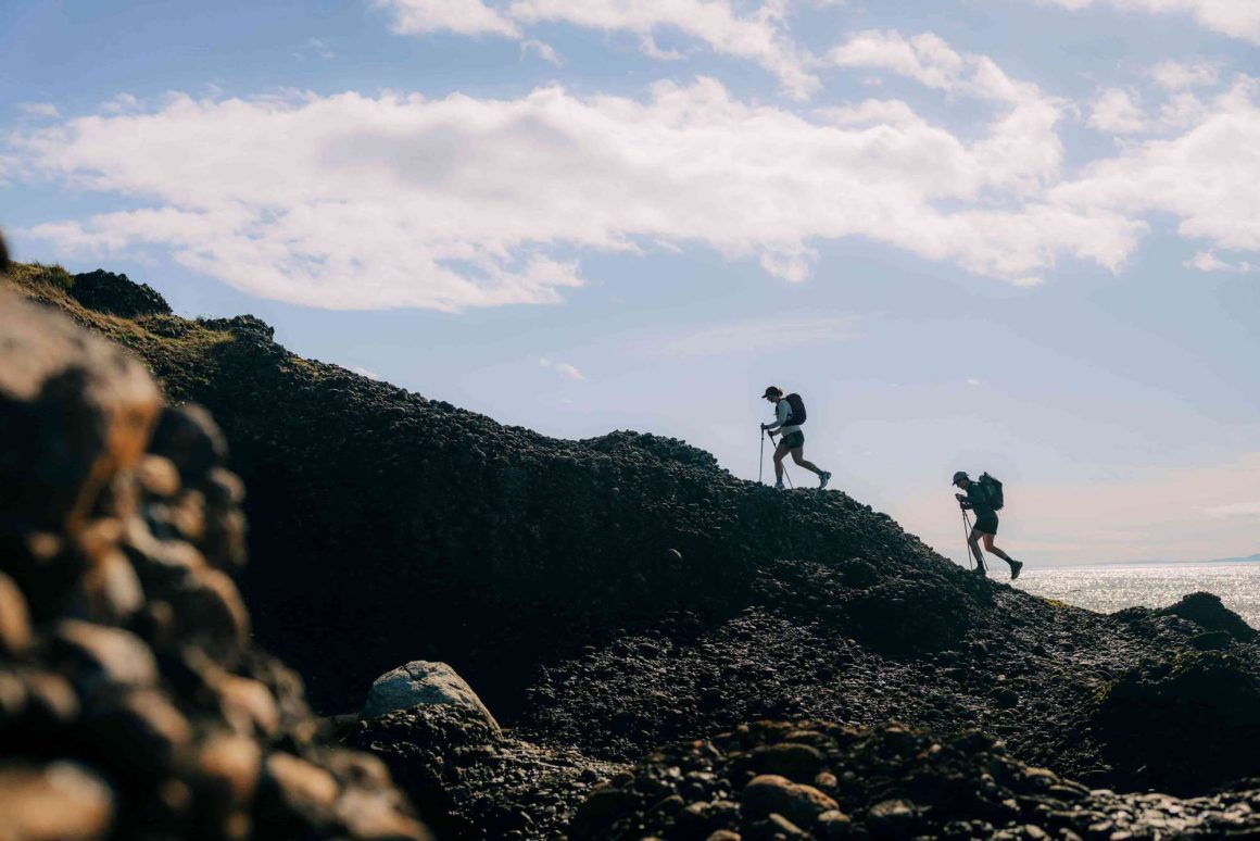 Two hikers on a mountain ridge.