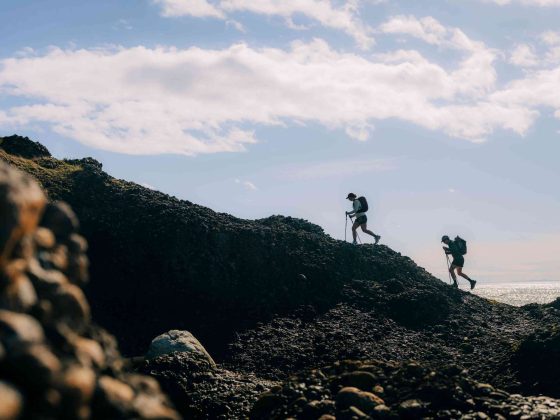 Two hikers on a mountain ridge.