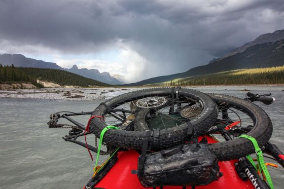 Paddling the upper reach of the Howse River, looking downriver to a storm rolling in.